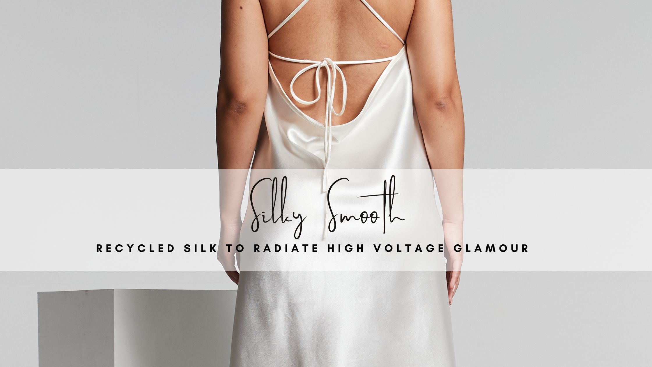 Ladies white silky slip dress with thin straps, backless design, and a draped cowl back. Perfect ivory silk dress for weddings, silky slip dress for hen parties and ivory satin midi dress for holidays.