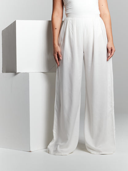 High waisted invisible zip closure high rise fit fitted on waist flared from waist to hem high rise box pleated pressed pleat wide leg straight leg trousers made from recycled eco rayon viscose that is lightweight soft and breathable. Trouser is suitable for beach holiday city break wedding guest hen party registry office wedding office garden party poolside 