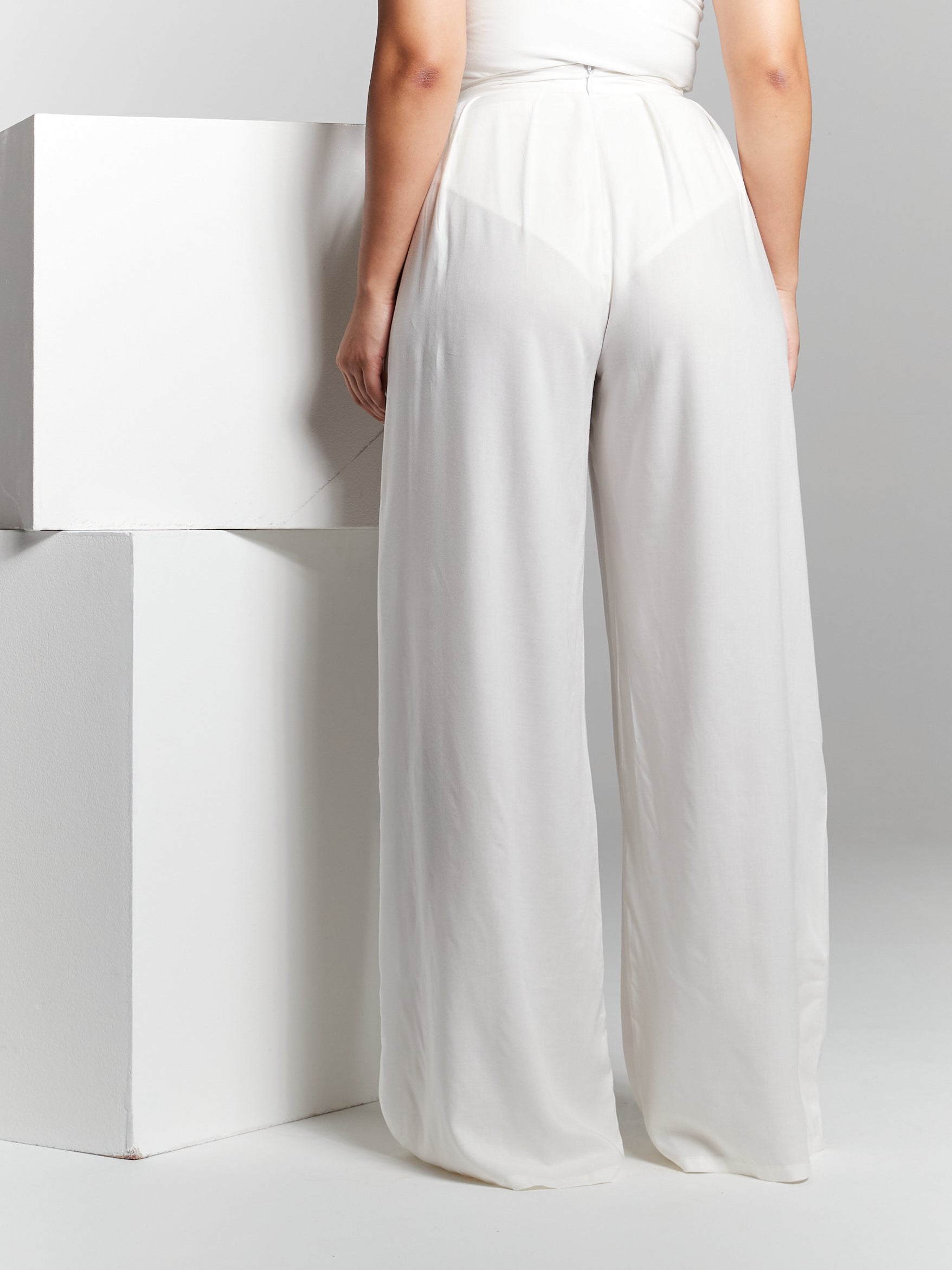 Elevate your sustainable style with our Eco Rayon Pleated Wide-Leg Trousers. These trousers offer a perfect blend of fashion-forward design and eco-conscious materials, making them a versatile addition to your wardrobe. Breezy style that can be customised to a leg length you prefer so you can wear it with heels to flats. Wide leg flared pants made from lightweight breathable recycled eco rayon viscose that is sustainable 